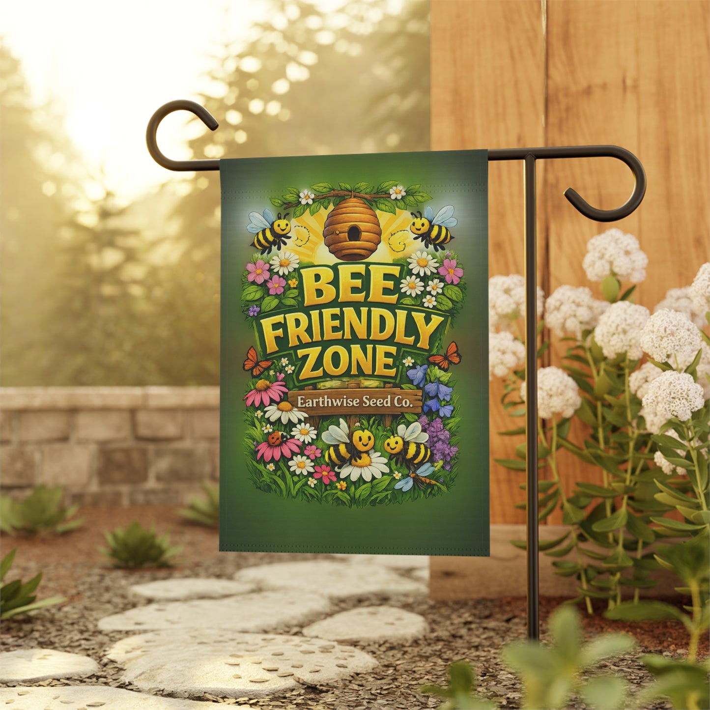 Garden flag with 'Bee Friendly Zone' design on a stand in a garden setting.